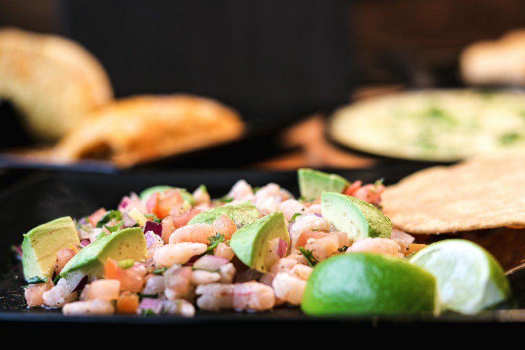 Mexican appetizer spread with quesadillas, nachos, guacamole, queso fundido and chicken wings at Tequila Fuego Longview Washington